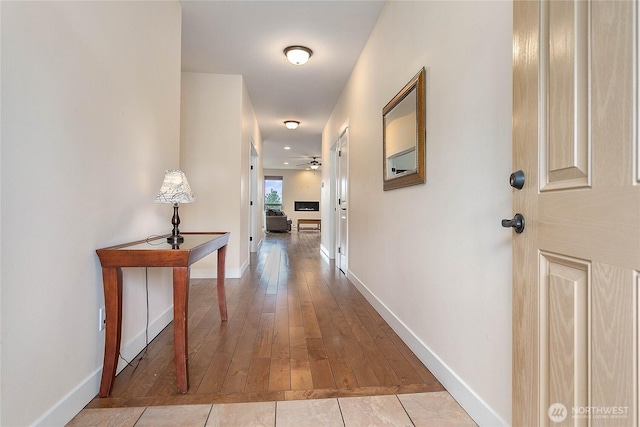 hall with tile patterned flooring and baseboards