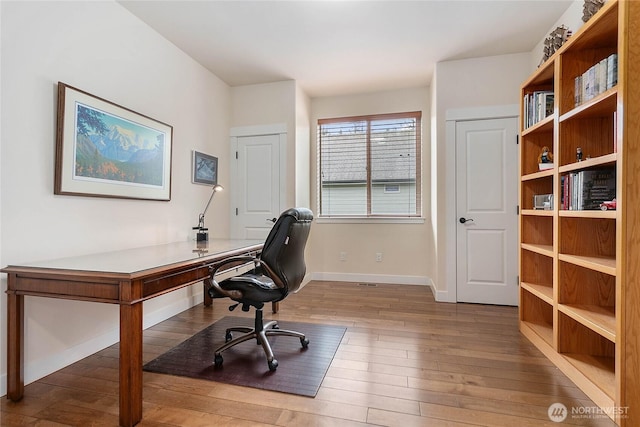 office area with wood finished floors and baseboards