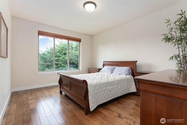 bedroom featuring dark wood-type flooring and baseboards