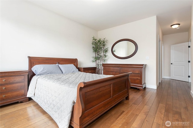 bedroom with baseboards and hardwood / wood-style floors