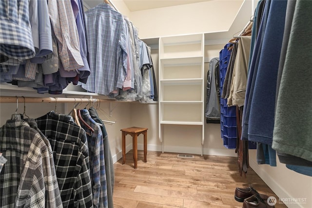 walk in closet with wood finished floors and visible vents