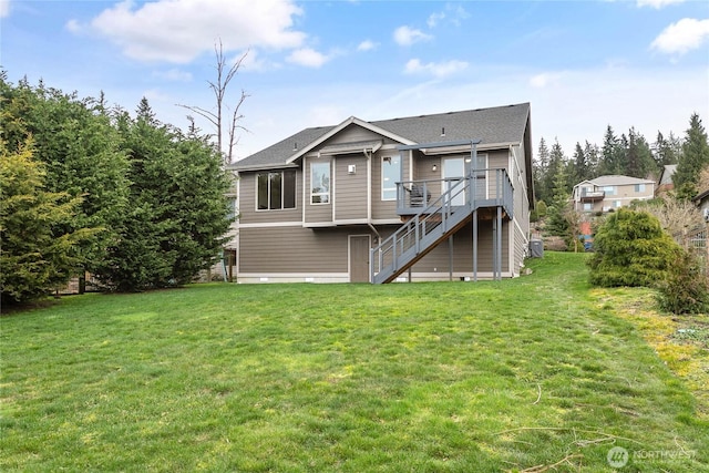 back of property featuring stairs, a yard, and a wooden deck