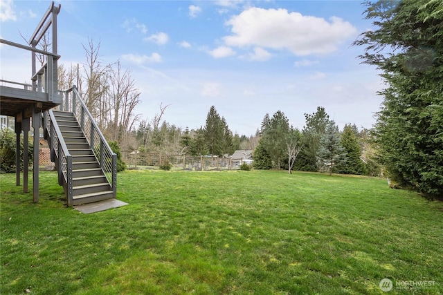 view of yard with stairway and a deck