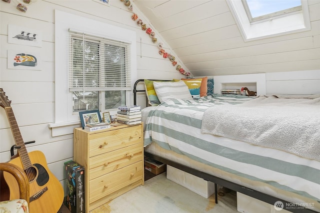 bedroom with lofted ceiling with skylight, concrete flooring, wood walls, and wooden ceiling