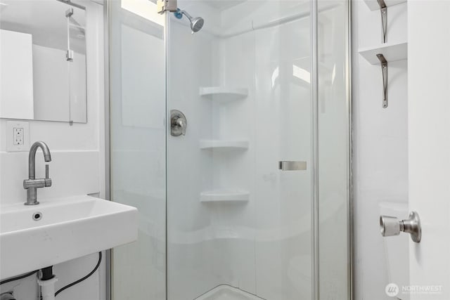 full bathroom with a sink and a stall shower