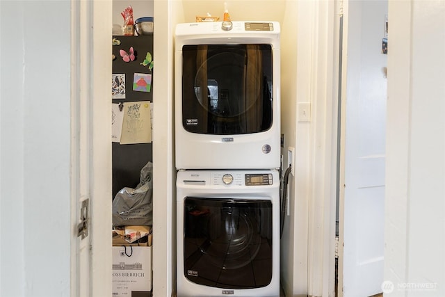 clothes washing area with laundry area and stacked washer / dryer