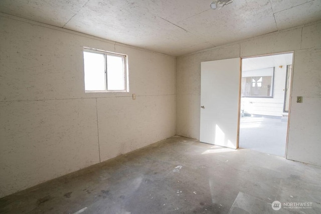 unfurnished room featuring concrete floors