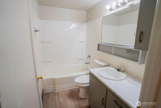 full bath with toilet, shower / tub combination, decorative backsplash, wood finished floors, and vanity