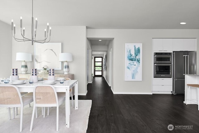 dining area featuring dark wood finished floors, recessed lighting, baseboards, and a chandelier