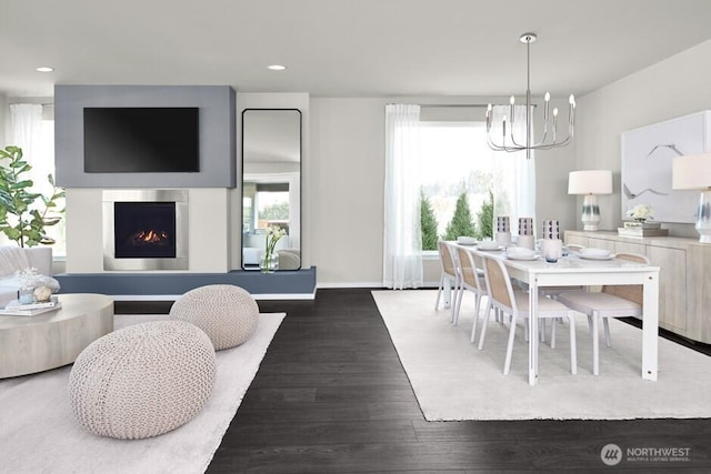 dining area with recessed lighting, a notable chandelier, a warm lit fireplace, and wood finished floors