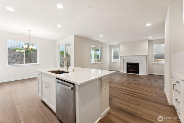 kitchen featuring a sink, stainless steel dishwasher, dark wood-style floors, recessed lighting, and white cabinets