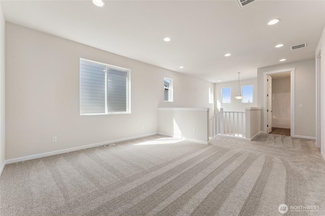 unfurnished room featuring baseboards, recessed lighting, visible vents, and light carpet