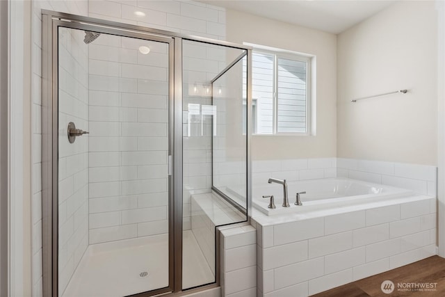 full bathroom with a garden tub, wood finished floors, and a stall shower