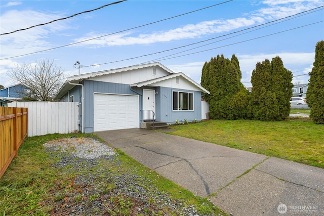 view of front of property featuring a garage, aphalt driveway, a front yard, and fence