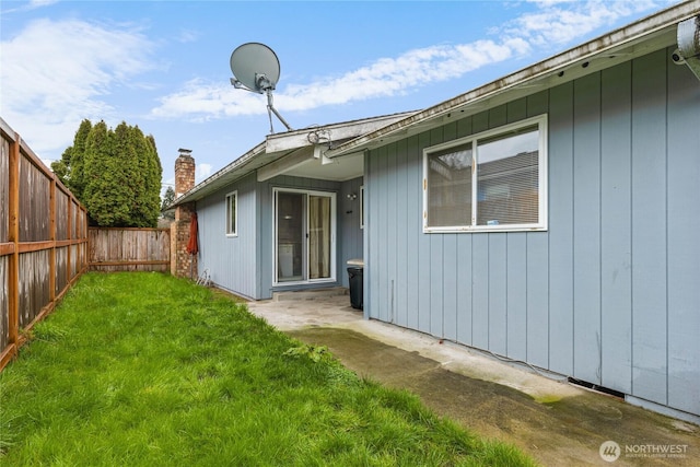 back of property featuring a yard and a fenced backyard