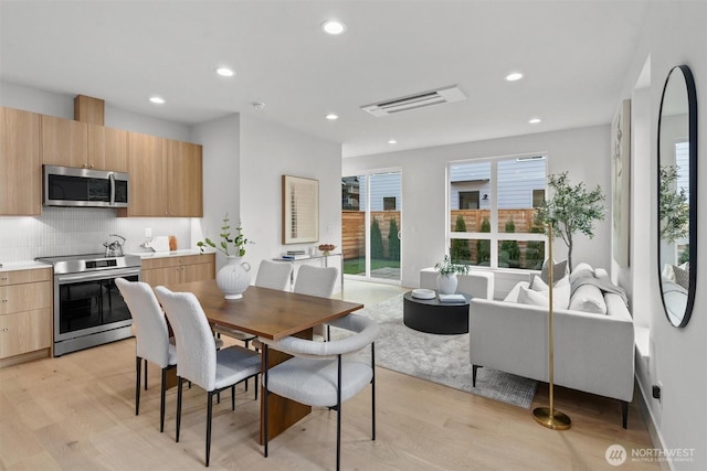 dining area with recessed lighting, visible vents, and light wood finished floors