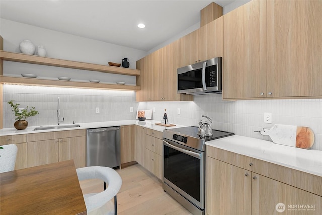 kitchen with open shelves, a sink, light brown cabinetry, stainless steel appliances, and tasteful backsplash