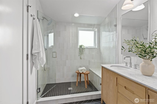 bathroom with a stall shower and vanity