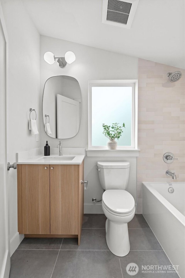 full bath with tile patterned flooring, visible vents, shower / washtub combination, toilet, and vanity