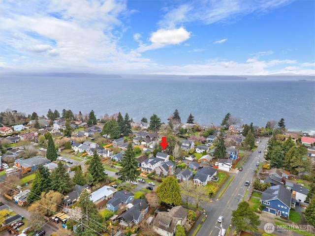 birds eye view of property with a residential view and a water view