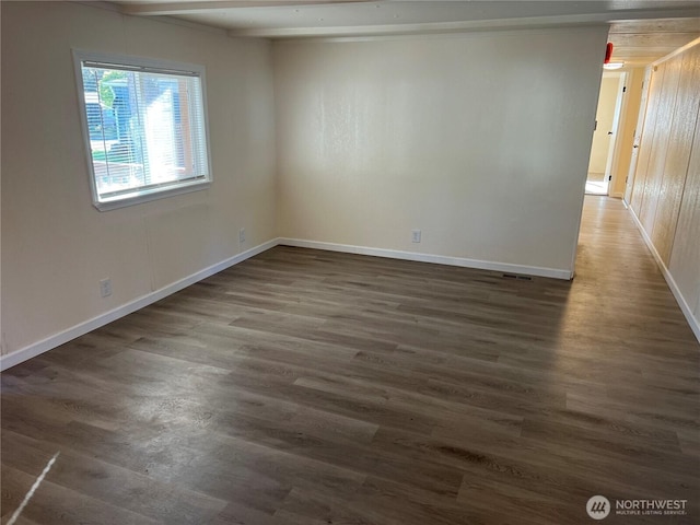 empty room with baseboards and wood finished floors