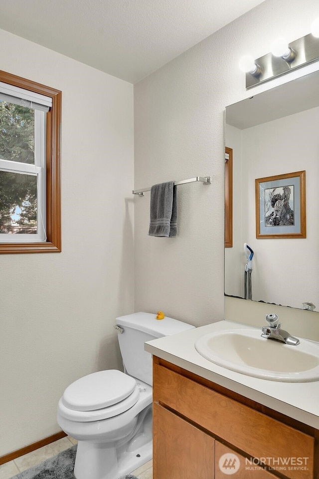 bathroom featuring vanity, toilet, and tile patterned flooring