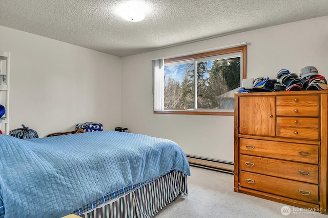 bedroom featuring light carpet, a textured ceiling, and a baseboard heating unit