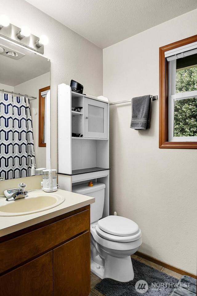 full bath with vanity, a shower with shower curtain, tile patterned flooring, a textured ceiling, and toilet