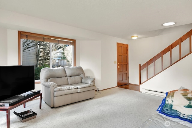 living room featuring a baseboard radiator, baseboards, and stairs