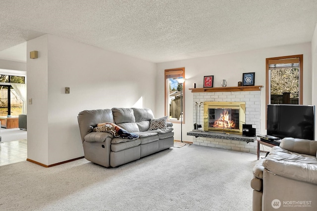 living area featuring baseboards, carpet, a brick fireplace, and a textured ceiling