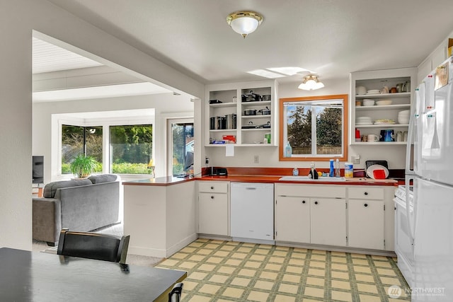 kitchen with open shelves, a sink, white cabinetry, white appliances, and light floors