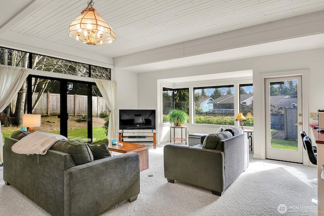 living area with an inviting chandelier and carpet floors