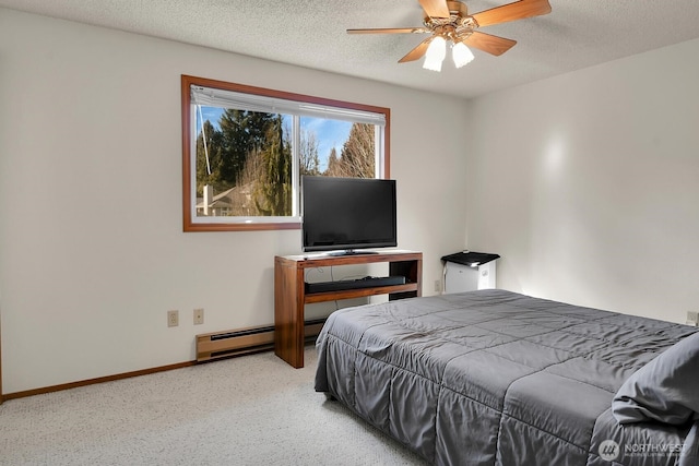 carpeted bedroom featuring baseboard heating, a textured ceiling, baseboards, and a ceiling fan