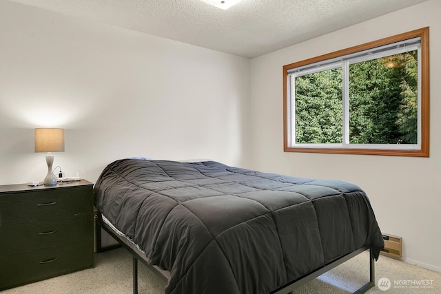 bedroom featuring a baseboard radiator, baseboards, and a textured ceiling