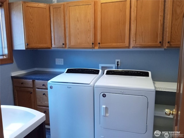 washroom with cabinet space and washing machine and dryer