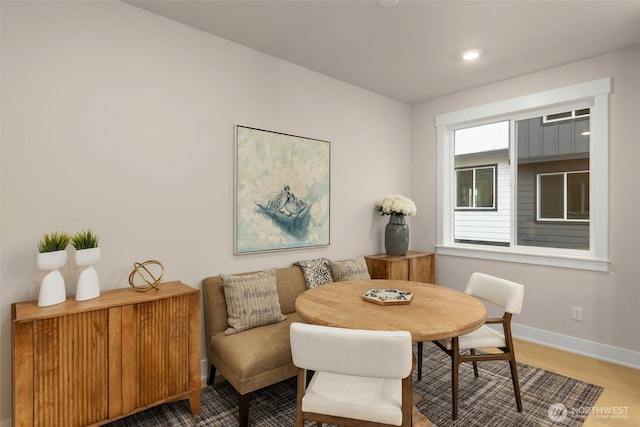 dining space with recessed lighting, baseboards, and wood finished floors