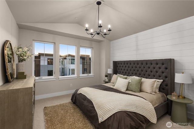 bedroom featuring carpet flooring, baseboards, lofted ceiling, and an inviting chandelier