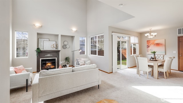 23806 SE 282nd St, Maple Valley, WA 98038 - living room featuring a glass covered fireplace, a notable chandelier, visible vents, and plenty of natural light
