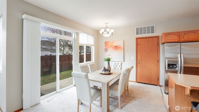 23806 SE 282nd St, Maple Valley, WA 98038 - dining area with a notable chandelier, light colored carpet, and visible vents