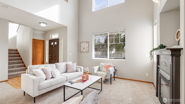 23806 SE 282nd St, Maple Valley, WA 98038 - living room with stairway, light colored carpet, a high ceiling, and baseboards
