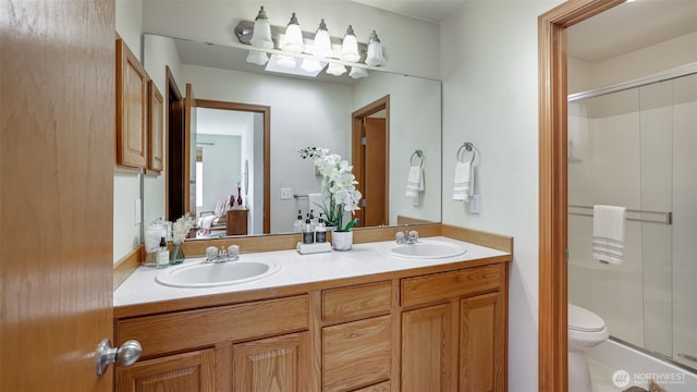23806 SE 282nd St, Maple Valley, WA 98038 - bathroom featuring double vanity, a stall shower, toilet, and a sink