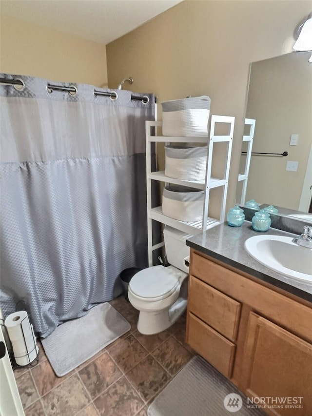 full bathroom with vanity, a shower with shower curtain, toilet, and tile patterned floors