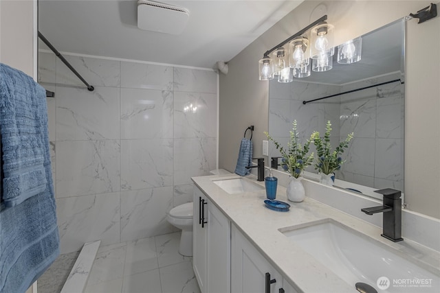 bathroom featuring walk in shower, toilet, marble finish floor, and a sink