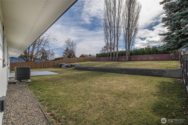 view of yard with a patio area, central AC unit, and a fenced backyard