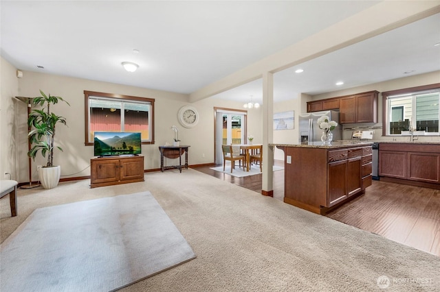 kitchen featuring a kitchen island, recessed lighting, stainless steel fridge, carpet floors, and baseboards