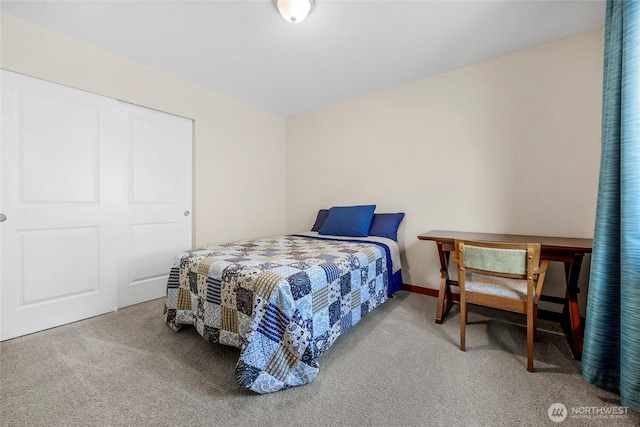 carpeted bedroom featuring baseboards