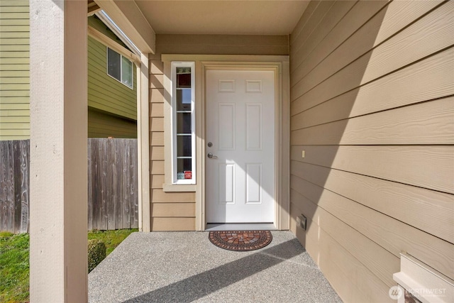 entrance to property featuring fence