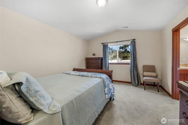 bedroom featuring baseboards, visible vents, lofted ceiling, and light carpet