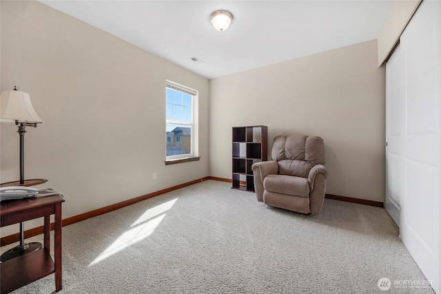 living area with carpet flooring, visible vents, and baseboards