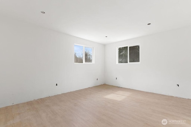 unfurnished room with wood finished floors